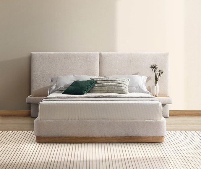 Upholstered platform bed with neutral bedding